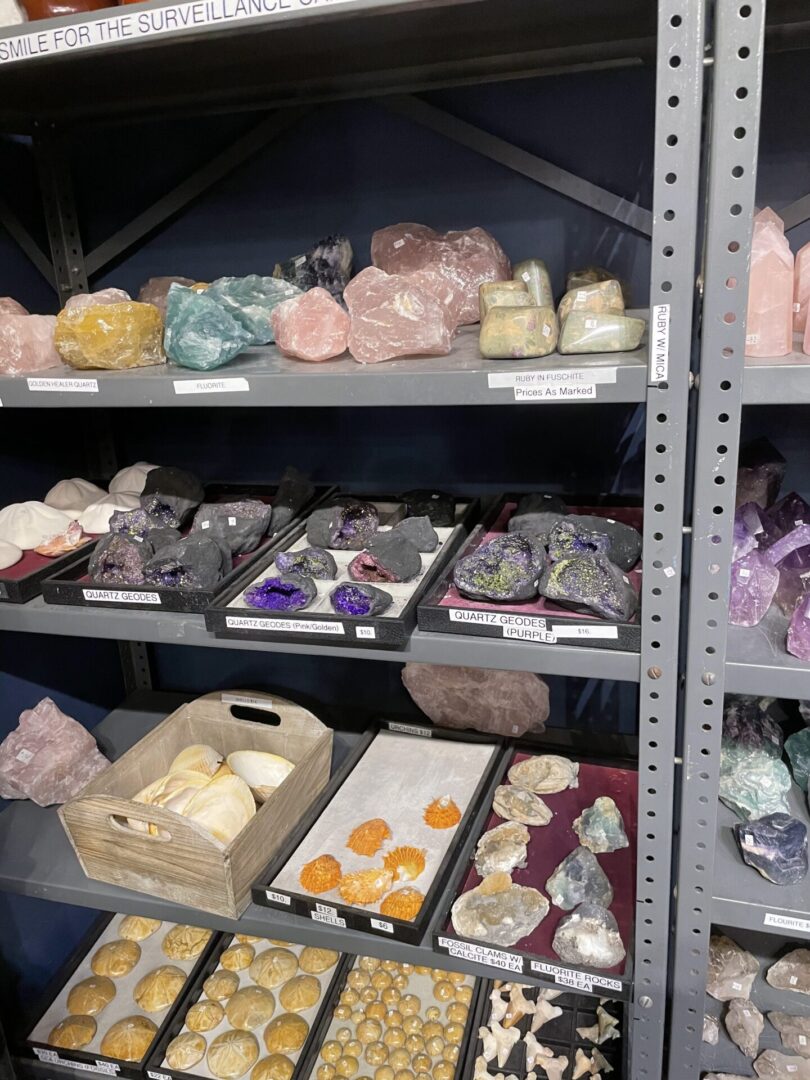 A shelf filled with lots of different colored stones.