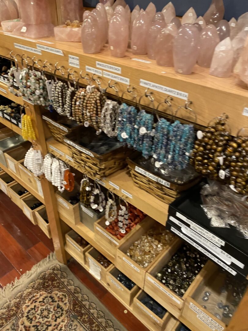 A shelf filled with lots of different types of jewelry.