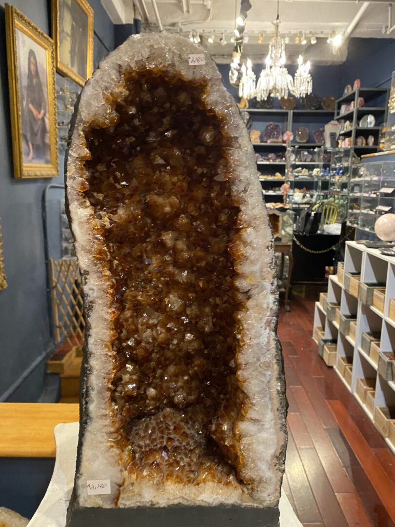 A large rock with brown and white crystals on it.