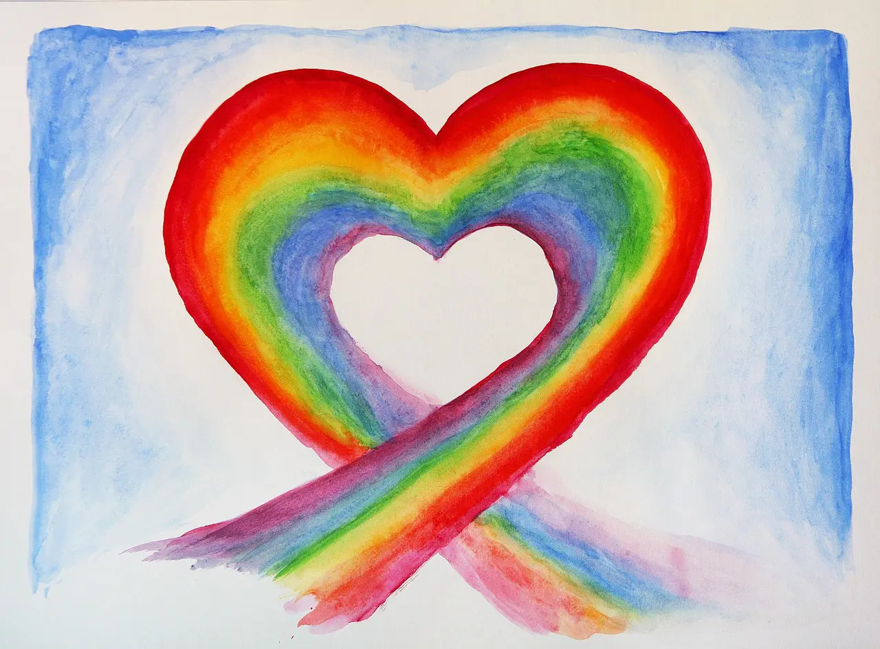 A rainbow heart painted on paper with white background.